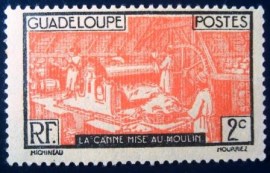 Selo postal de Guadalupe de 1928 Sugar cane in the mill