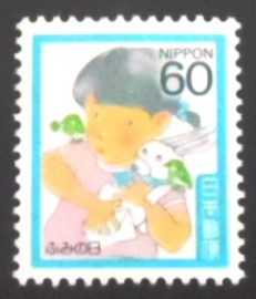 Selo postal do Japão de 1986 Girl holding rabbit and letter