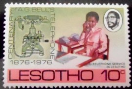 Selo postal do Lesotho de 1976 Early handset and woman using telephone